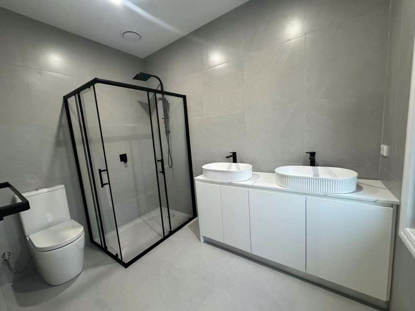 Bathroom with double vanity and shower