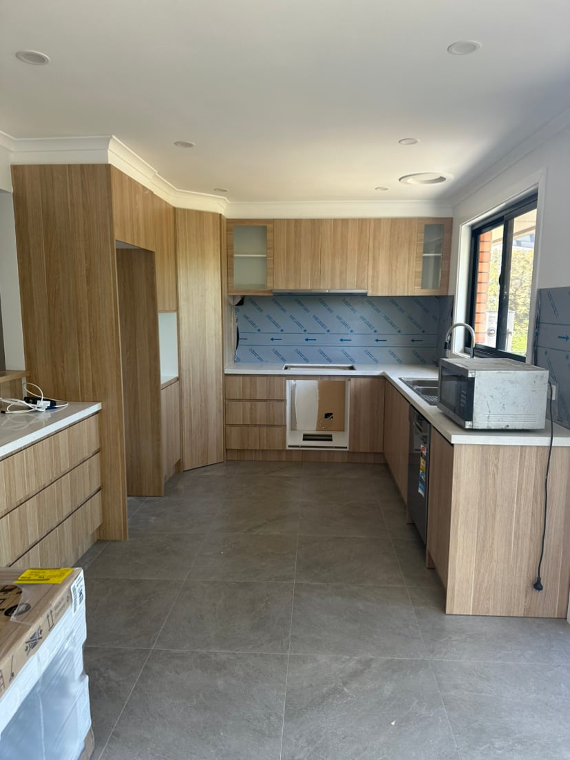 Timber kitchen cabinetry and tiled flooring