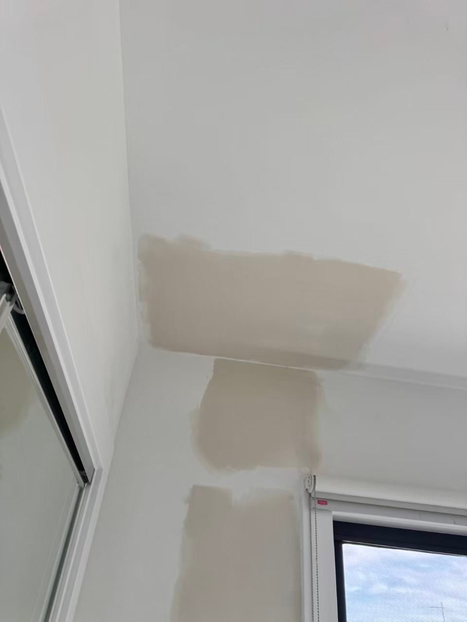 Plaster patching at a wall and ceiling junction