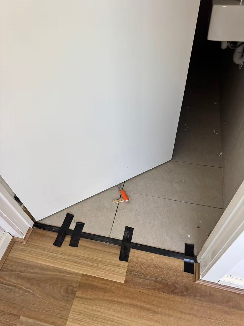 Prepared threshold at a bathroom doorway